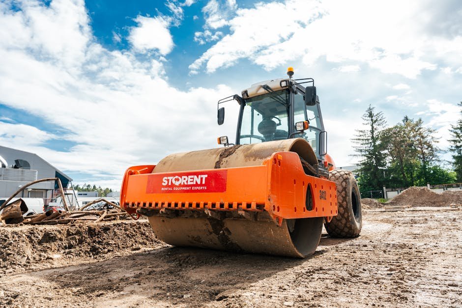 Large vibratory roller compactor on a sunny construction site in Keila, Estonia.